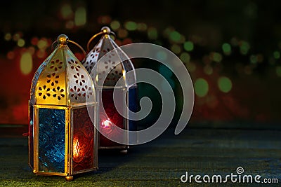 Two colorful oriental Lamp lanterns burn with candles with color Stock Photo