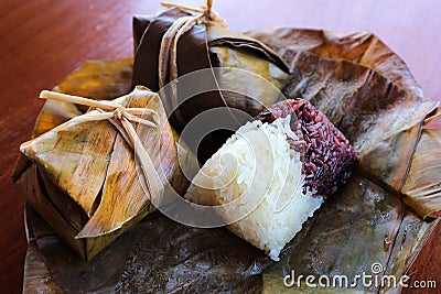 Two colour Sticky rice wrapped with banana leaf Stock Photo