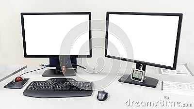 Two computer monitors are on the table in the office. On the monitors white screen to insert images or text Stock Photo