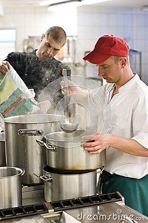 Two cooks industrial kitchen Stock Photo