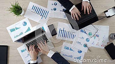 Two corporate employees typing on laptops, working on business project, top view Stock Photo