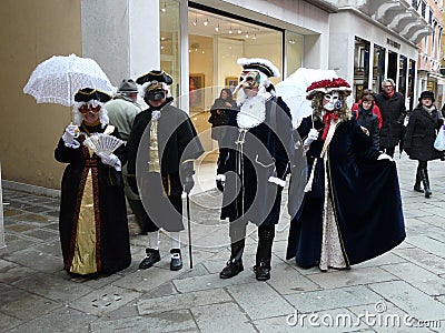 Two couples in carnival costumes, Venice, Italy. February 2010 Editorial Stock Photo