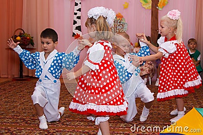 Two couples children dancing in the children's holiday Editorial Stock Photo