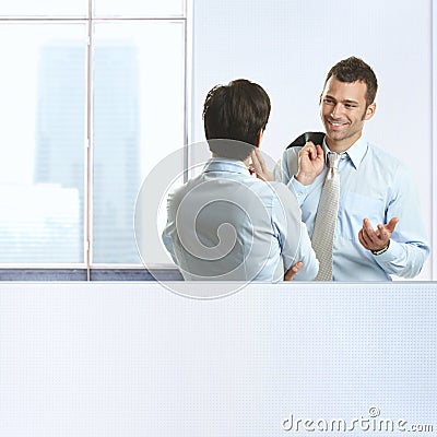 Two coworkers chatting in office Stock Photo