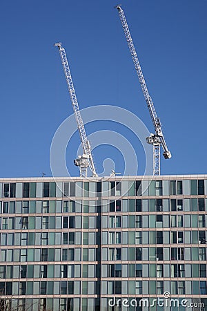 Two cranes working on a skyrise building on Avebury Boulevard in Milton Keynes, Buckinghamshire in the UK Editorial Stock Photo