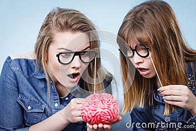 Two crazy women friends thinking Stock Photo