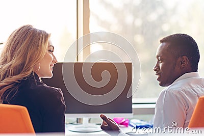Two creative millenial small business owners working on social media strategy using a computer Stock Photo