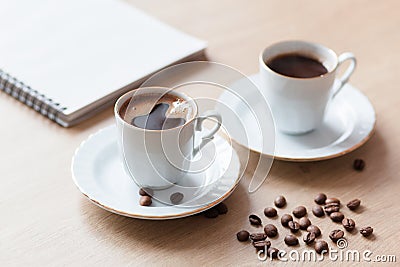 Two cup of turkish coffee close-up on a wooden background, coffee beans. Pleasant morning and cheerfulness Stock Photo