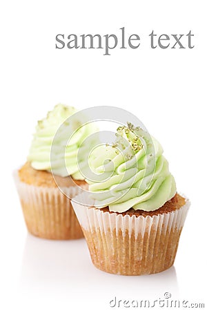 Two cupcakes with green cream isolated on white background Stock Photo