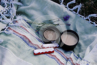 Two cups of coffee, chocolate and a branch of lavender in nature Stock Photo