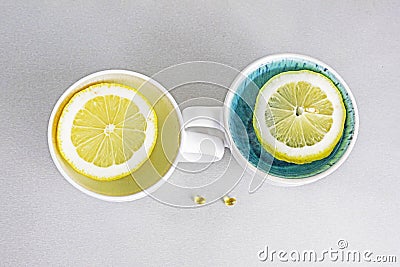 two cups with lemon slices on the table and vitamin D. Psychology health Stock Photo