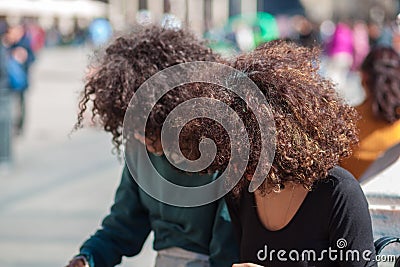 Two Curly haird girls in the square of Milan Stock Photo