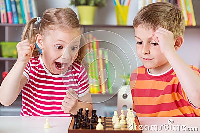 Two cute children playing chess Stock Photo