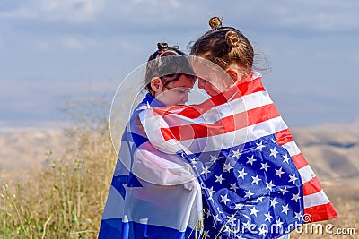 Two cute girls with American and Israeli flags. Two nations one heart concept. Stock Photo