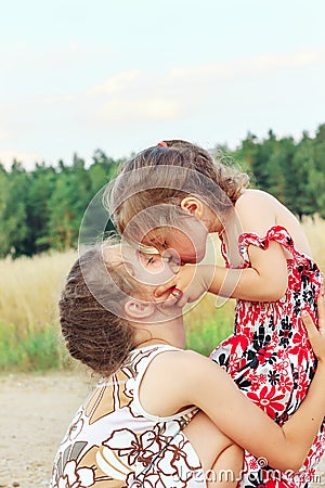Two Cute happy little girls is smiling and hugging on summer filed Stock Photo