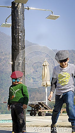 Two stylish kids wearing caps having fun together Editorial Stock Photo