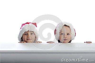 Two cute little boys with xmas hats Stock Photo