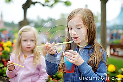 Two cute little sisters drinking frozen slushie drink Stock Photo