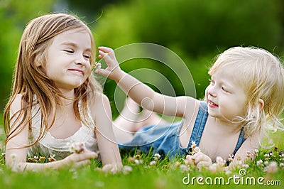Two Cute Little Sisters Laying In The Grass Stock Photo - Image: 42482945