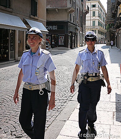 Two cute policewoman on patrol on the streets of the historic streets of the ancient city of Verona Italy Editorial Stock Photo