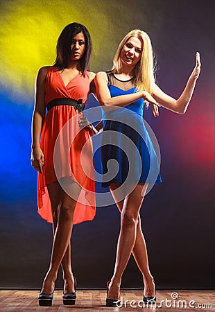 Two dancing women in dresses. Stock Photo