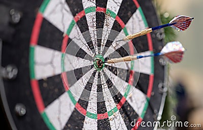 Two darts sticking out of wooden target closeup Stock Photo