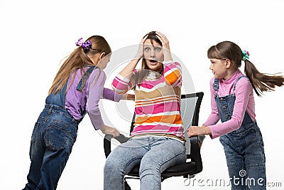 Two daughters unwind mom in an office chair Stock Photo