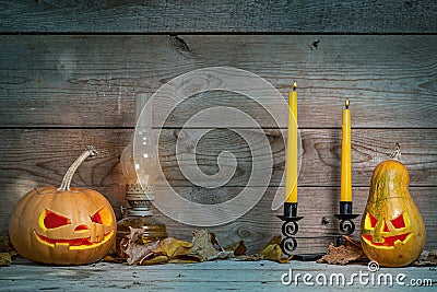 Couple of decorated pumpkins for a Halloween on a mystical autumn background with candles and gas lamp Editorial Stock Photo