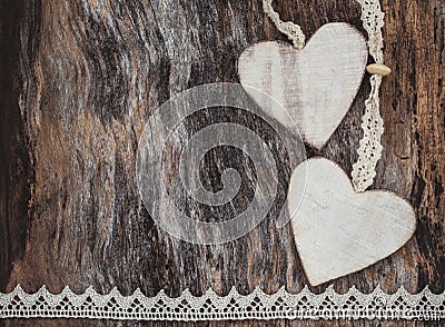 Two decorative hearts on aged wooden background. Valentine Day concept. Stock Photo