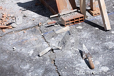 Various masonry and brickwork tools being used on a construction site Stock Photo