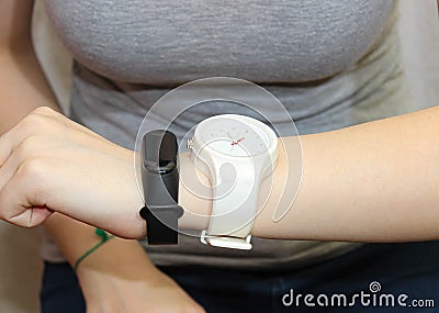 Two different wristwatches are worn on the same female hand Stock Photo