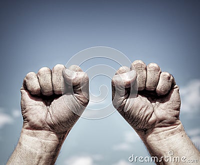 Two dirty male hands clenched in fist Stock Photo