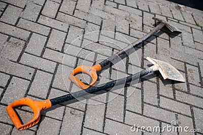 Two dirty shovels on the pavement, the concept of construction work Stock Photo
