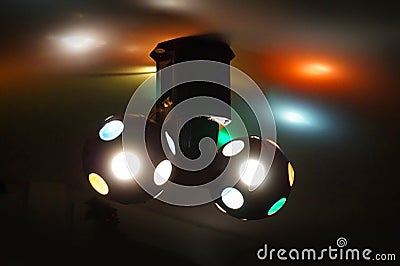 Two disco balls rotating on a ceiling, colorful lights Stock Photo