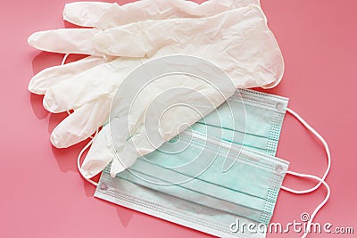 Two disposable medical masks and a pair of latex gloves Stock Photo