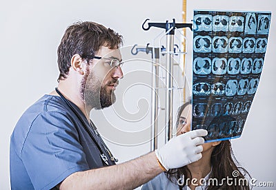 Two doctors emit X-ray photo of the patient to identify the problem. Professional conversation, consultation of doctors. The work Stock Photo