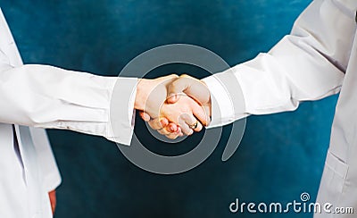 Two doctors shaking hands close up Stock Photo