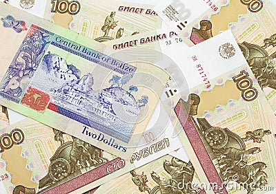 A two dollar bill from Belize with Russian one hundred ruble bills Stock Photo