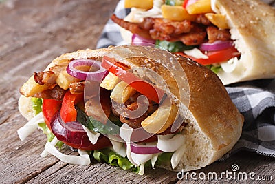 Two doner kebab with meat, vegetables and fries in pita bread Stock Photo