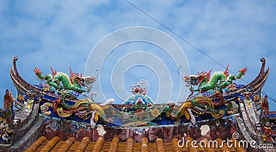 Two dragon statue on temple roof Stock Photo