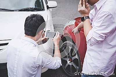 Two drivers man arguing after a car traffic accident collision and making phone call to Insurance Agent and take a photo, Traffic Stock Photo