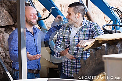 Two drivers working with tractor Stock Photo