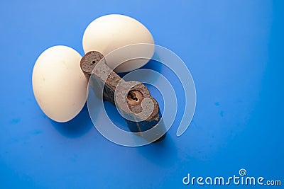 Two eggs on lock,blue background,iron Oran in the form of a padlock Stock Photo