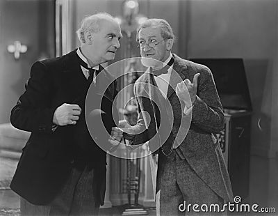 Two elderly men share the gossip Stock Photo