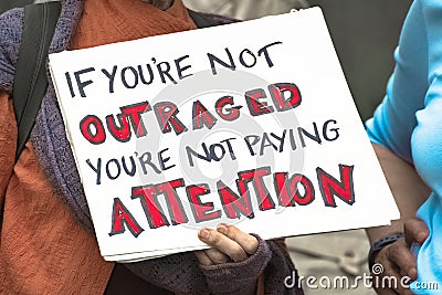 Two elderly women hold an outrage sign in protest Stock Photo