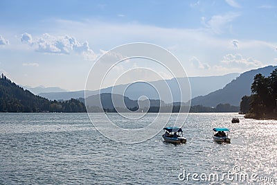 two electric mini boats on ossiacher see lake in summer. Editorial Stock Photo