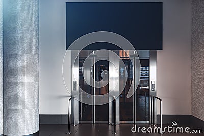 Two elevators with closed doors and banner mockup Stock Photo