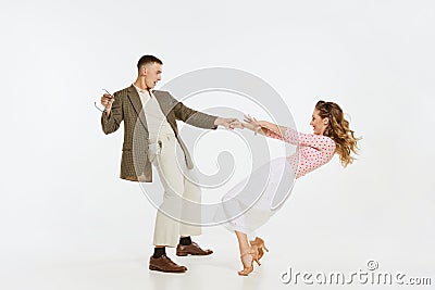 Two emotional dancers in vintage style clothes dancing swing dance, rock-and-roll or lindy hop on white Stock Photo