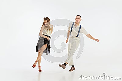 Two emotional dancers in vintage style clothes dancing swing dance, rock-and-roll or lindy hop on white Stock Photo