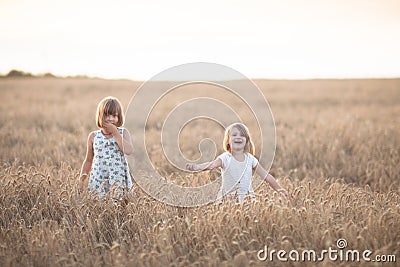 Two emotional sisters girls dance at sunset Stock Photo